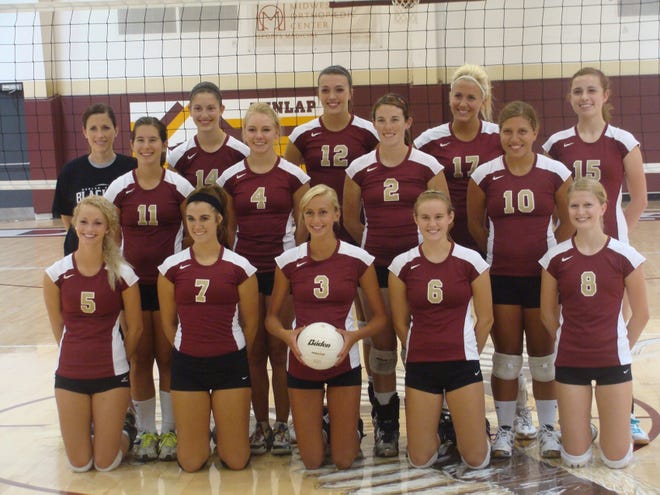 The varsity volleyball team poses for its team picture.
