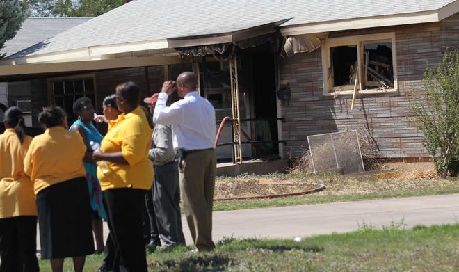 Danielle Anderson, 72, was pulled from her burning house in the 1800 block of East 26th Street on Wednesday by Dunbar Middle School teaching instructor Jason Skelton and an unidentified man.