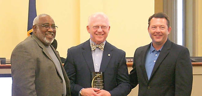 Courtesy of the Jasper County Sun Beaufort County Coroner Ed Allen (left) and County, Jasper County Councilman Martin Sauls IV presents Jasper County Coroner Martin Sauls III the Lifetime Achievement Award at the Aug. 15 council meeting.