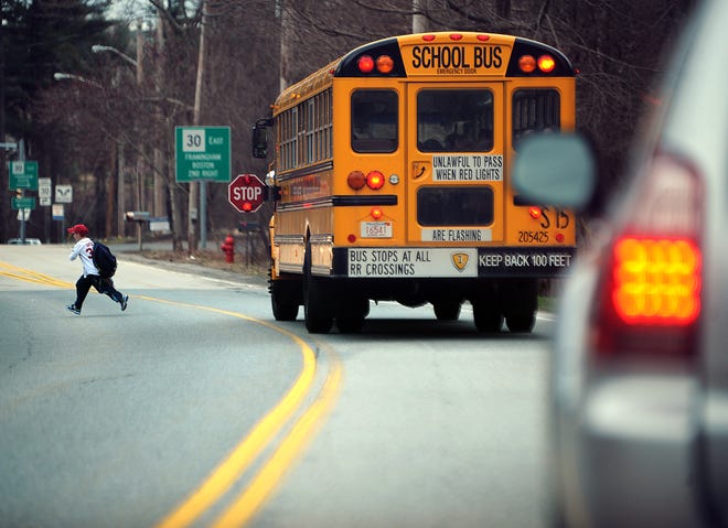 A school bus drops off a student.