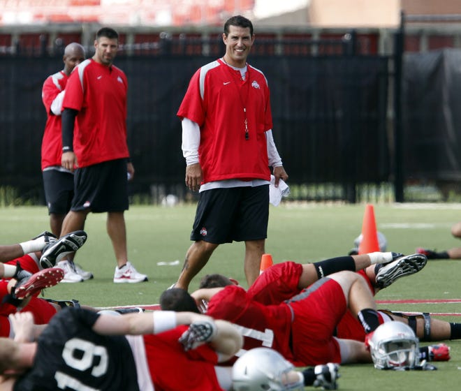 Ohio State head coach Luke Fickell watches as his players stretch after the first day of football practice Monday, Aug 8, 2011, in Columbus.
