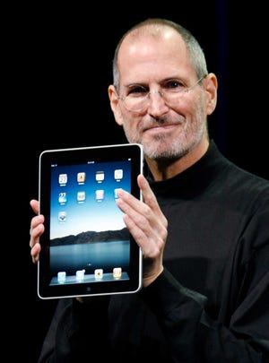 FILE - In this Jan. 27, 2010 file photo, Apple CEO Steve Jobs holds the new iPad during a product announcement in San Francisco. Apple Inc. on Wednesday, Aug. 24, 2011 said Jobs is resigning as CEO, effective immediately. He will be replaced by Tim Cook, who was the company's chief operating officer. It said Jobs has been elected as Apple's chairman. (AP Photo/Paul Sakuma, File)