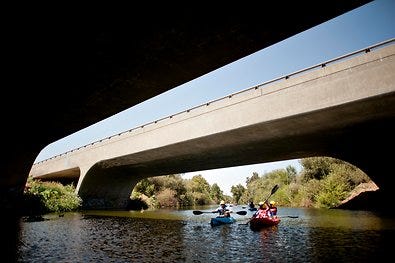 A group kayaks down the Los Angeles River as part of a pilot program put on by the Los Angeles Conservation Corps.