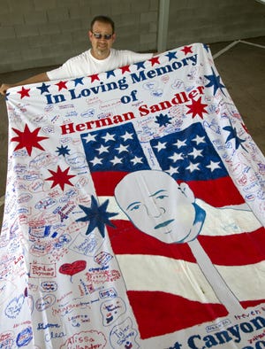 Kevin Held displays a section of a 9/11 memorial quilt that his charity was to create. It is not yet finished.