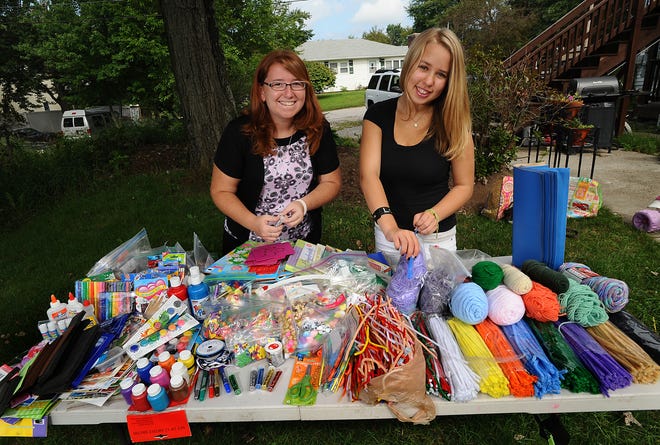 Wayland Girl Scout Michelle Casey, 14, right, and her cousin Lisa Lavezzo, 23, of Natick, with art supplies Casey has collected for children in Honduras as part of her Silver Award service project. Her cousin is serving in the Peace Corps in Honduras.