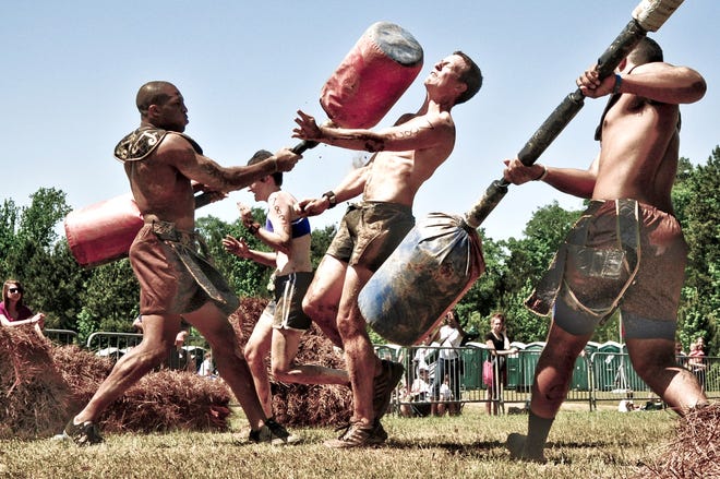 Shown in the photo is a group of Spartans fighting off gladiators hitting them with sticks, but it’s just one event that the participants have to endure throughout the process that also includes basic obstacles of swimming and biking when energy levels are down, and running and jumping through fire. It will commence once again at the Amesbury Sports Park this weekend.