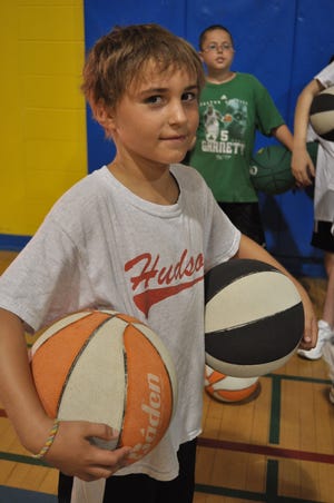 Troy O’Connor, 10, of Hudson, waits his turn at the hoop.