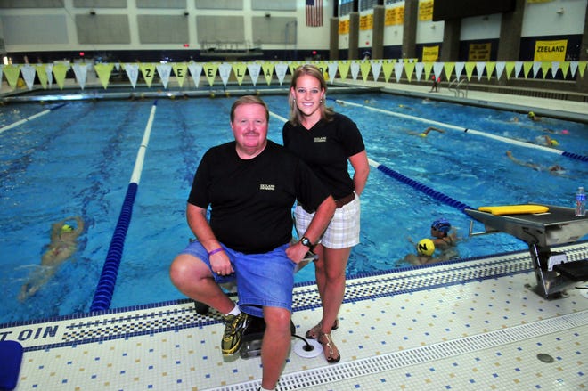 Mike Torrey, left, and Lisa (Ekdom) Engers are co-head coaches for the Zeeland girls swimming team this fall.