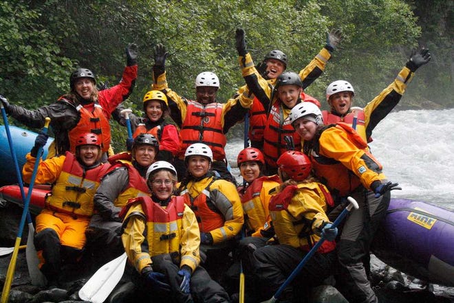 Participants pose for a group photo before a whitewater rafting trip on Crow Creek, near Girdwood, Alaska during an Alaska Adventure excursion. The event was organized by Tragedy Assistance Program for Survivors for a group of about 75 widows of military veterans to share memories of loved ones while hiking rugged trails and rafting the rapids.