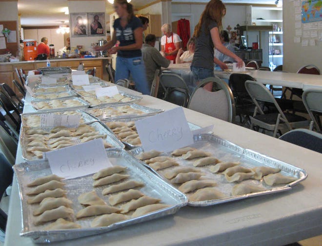Members of St. Mary Magdalene Orthodox Church set out trays of homemade pierogis to be packed and frozen for the monthly bake sale.
