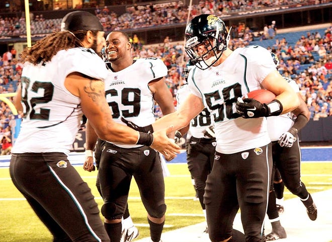 Jacksonville Jaguars' Jacob Cutrera (58) celebrates with teammates after returning an interception for a touchdown in the third quarter of Saturday's 35-32 loss to Buffalo.