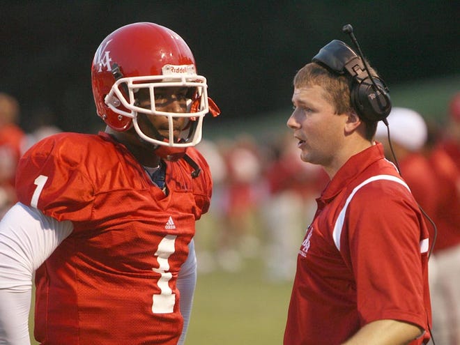 University of West Alabama offensive coordinator Will Hall, right, speaks with quarterback Deon Williams as UWA takes on Harding September 3, 2009 at the UWA campus in Livingston.