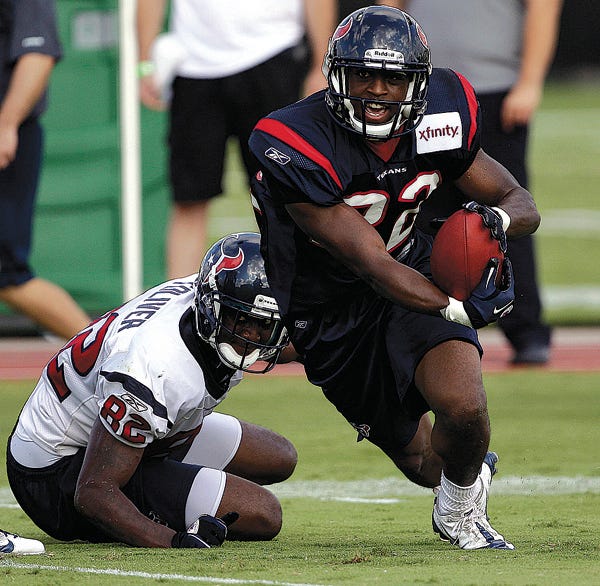 Houston Texans cornerback Sherrick McManis (22) steals the ball from wide receiver Terrence Toliver (82) during an NFL football training camp practice Wednesday, Aug. 3, 2011, in Houston. (AP Photo/David J. Phillip)