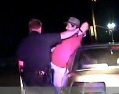 This image captured from cruiser camera video shows William Bartlett being detained by Canton patrolmen Daniel Harless and Mark Diels during a traffic stop on June 8.