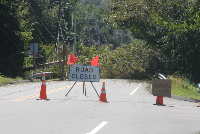 A fallen tree and power lines lies across Rt. 164 in Preton City the day after Tropical Storm Irene passed the region. Signs at the intersection of Rt. 164 and Old Shetucket Rd in Preston City are informing drivers how to get o the casino and to Norwich.