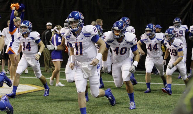 FILE - This Nov. 12, 2010, file photo shows Boise State quarterback Kellen Moore (11) running onto the field in the Kibbie Dome for an NCAA college football game against Idaho, in Moscow, Idaho. Thanks to the Heisman-finalist and a talented cast around him, the Broncos are once again going to be at the center of debate about their worthiness on the national scene. (AP Photo/Ted S. Warren, File)