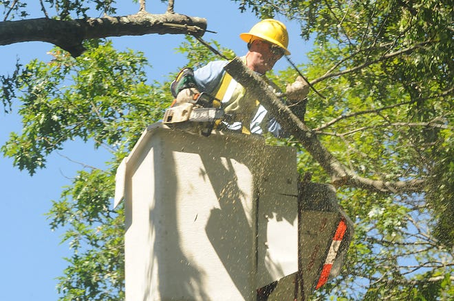 A lineman works on Tremont Street in Taunton, 
repairing storm damage Monday, Aug. 29.