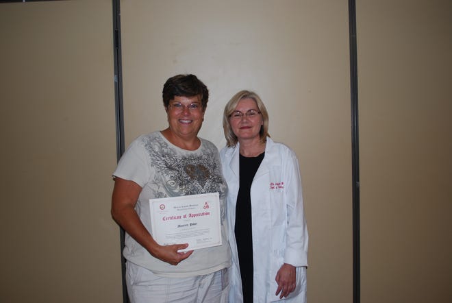 Marlborough resident Maureen Power recently joined the "2 1/2 Gallon Club." Here she joins Elzbieta Griffiths, MD, medical director of the Blood Bank and Blood Donor Center at Mount Auburn Hospital.