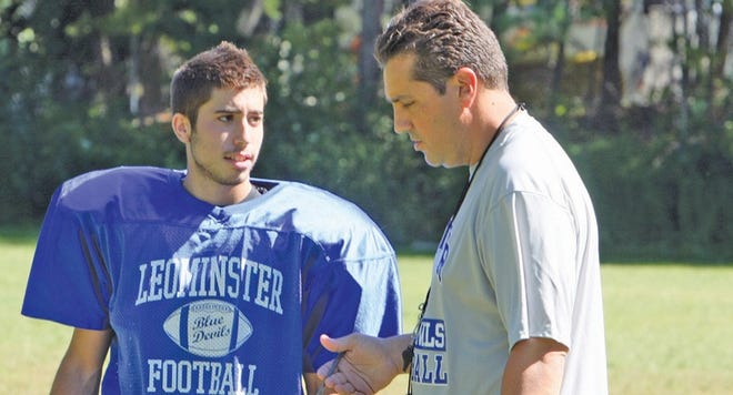 New head coach, Dave Palazzi, talks with senior Mike Kelly during practice this week.