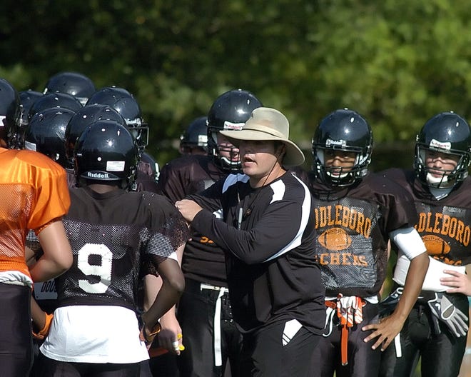 Middleboro head football coach, Pat Kingman, gives his team a pep talk before taking the field in a football scrimmage against Dover-Sherborn on Wednesday, Aug. 31, 2011