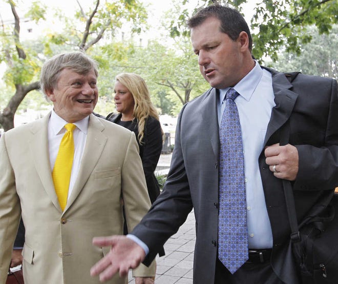 Roger Clemens, right, arrives at federal court yesterday in Washington with attorney Rusty Hardin.