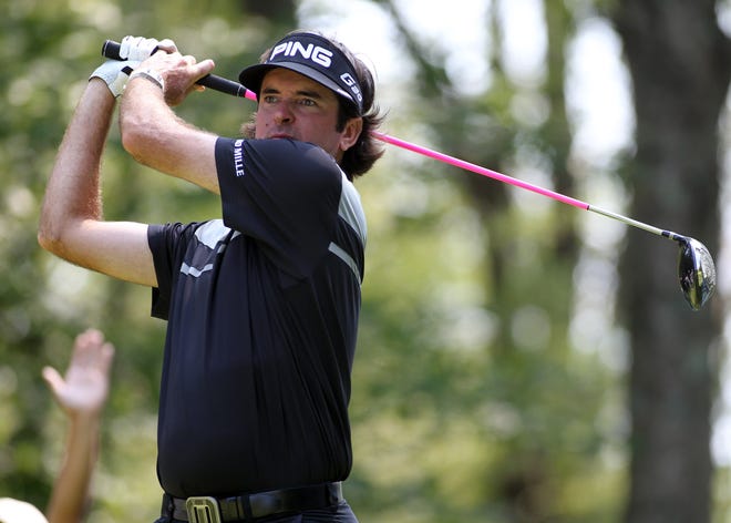 Bubba Watson watches his tee shot on the ninth hole.