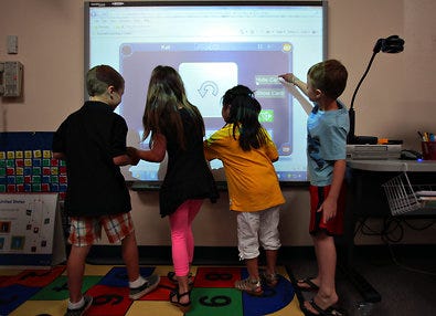 Students using an interactive whiteboard, part of an ambitious technology plan in the Kyrene School District in Arizona.