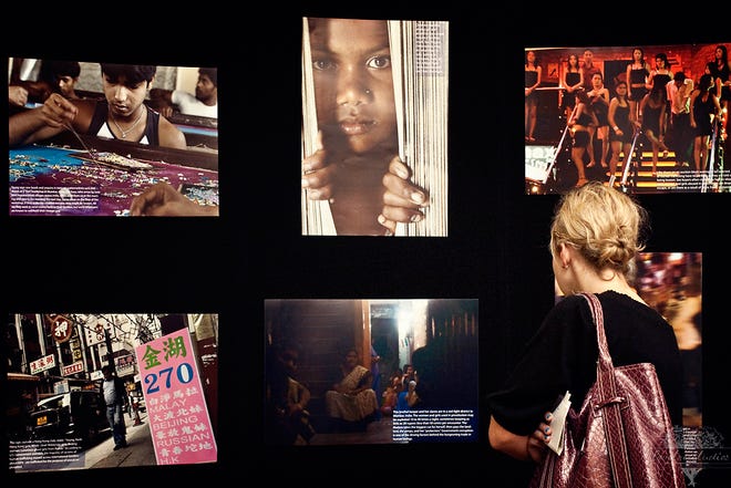 An audience member at the 2010 Freedom by Fashion fundraiser examines an informational display about human trafficking.