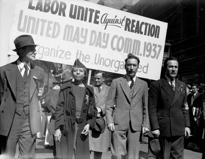 Edith Ransom and Charles Zimmerman (center) of ILGWU Local 22 march with others in the 1937 May Day parade.