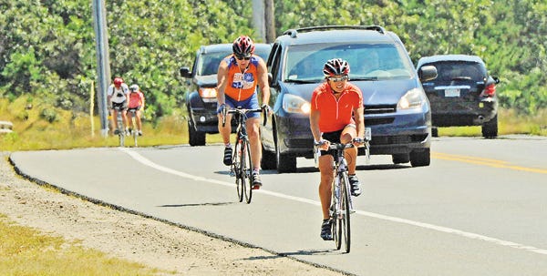 Bicyclists pedal along Route 6 in Truro last week. Safety concerns have generated proposals to extend the terminus of the Cape Cod Rail Trail from Wellfleet to Provincetown.