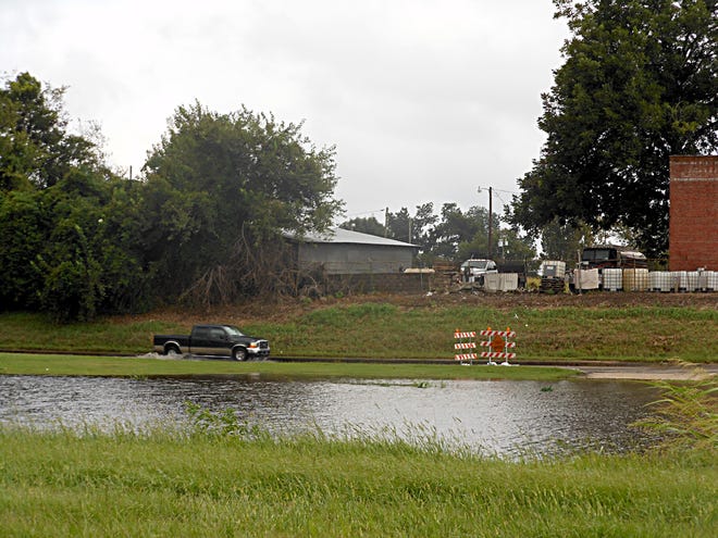 A truck navigates through high water on Highway 308 in Donaldsonville Sunday.