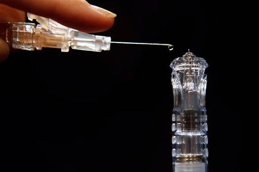 Flu shots have long been injected deep into muscle, requiring a needle an inch long or longer, such as the needle seen at left. However, a new version named: Sanofi Pasteur's Fluzone Intradermal, hitting the market this fall, at right, is less than a tenth of an inch long, the first flu vaccine that works by injecting just into the skin. The new needle is about as long as a single drop of fluid, as demonstrated in Washington, on Tuesday, Aug. 30, 2011.