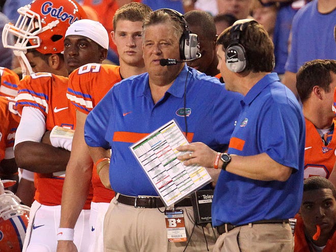 The experience of coaching in the NFL for Charlie Weis, left, and Will Muschamp has helped in recruiting.
