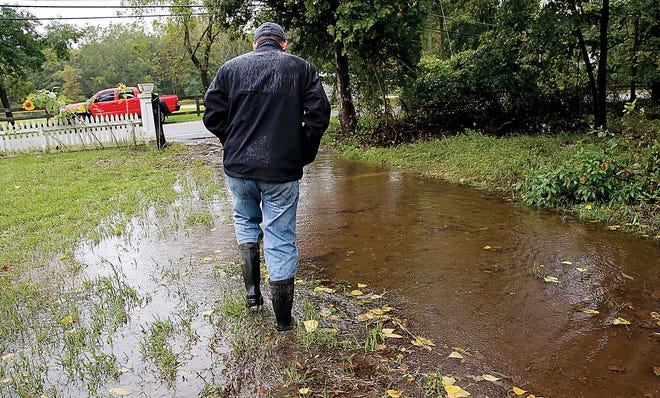 Photo by Sara Hudock-Cole/New Jersey Herald
 
Mark Bastek, of Newton-Swartswood Road, sloshes through his flooded front yard in Swartswood Tuesday. Bastek's home was inundated a week ago when a nearby creek overflowed during Hurricane Irene. Although he managed to pump out his flooded basement from the last storm, the water began to rise again as heavy rains fell Tuesday.