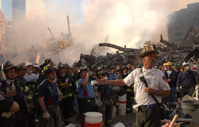 New York City, NY, September 13, 2001 --
A New York City Fire Chief addresses firefighters concerning the shifting of surrounding buildings at the World Trade Center crash site.

Photo by Andrea Booher/ FEMA Photo News