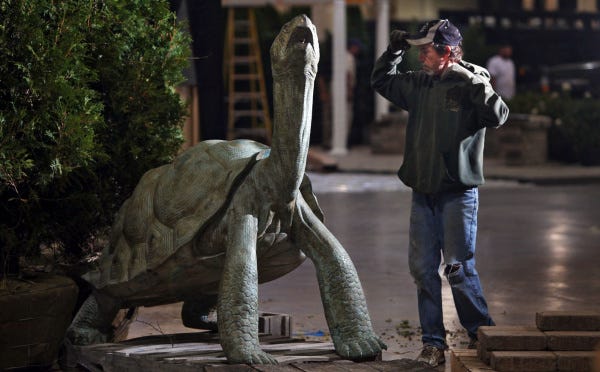 Stick a neck outDennis Cook of Cedarbrook Landscaping and Garden Center in Dublin works with a tortoise fountain display for an exhibit for the Best of Fall Home Show that runs Friday through Sunday at the Ohio Expo Center. The 300-pound creature is made mostly of copper.