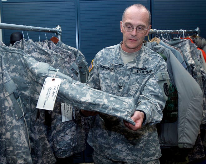 Col. Gaston P. Bathalon points out some of the clothing being developed at Natick Labs.