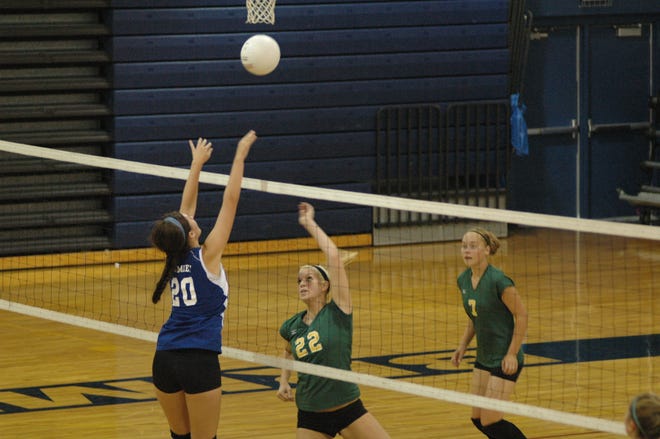Engadine’s Kacey Bigelow (22) hits a shot over the block of Brimley’s Whitney Frazier (20), while the Eagles’ Krista Metcalf (7) looks on during Thursday’s EUP volleyball match.