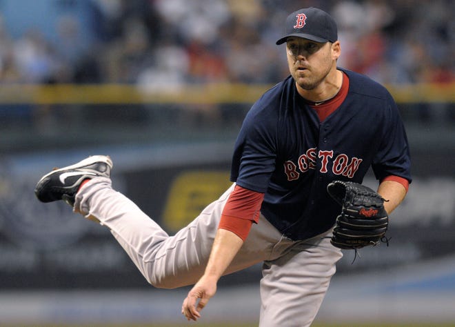 Red Sox starting pitcher John Lackey follows through on a pitch at Tampa Bay last night.