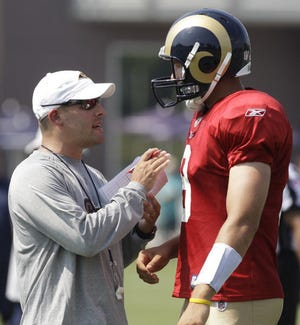 FILE - This Aug. 1, 2011 file photo shows new St. Louis Rams offensive coordinator Josh McDaniels, left, talking to quarterback Sam Bradford during NFL football training camp at the Rams' training facility in St. Louis. The Rams promise a more unpredictable offense this season under McDaniels, with the first test coming in a preseason game against the Indianapolis Colts this Saturday. (AP Photo/Jeff Roberson, File) ORG XMIT: MOJR402