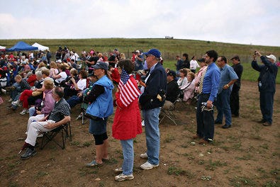 Visitors atop a hill watched a dedication ceremony at the crash site in Shanksville, Pa.