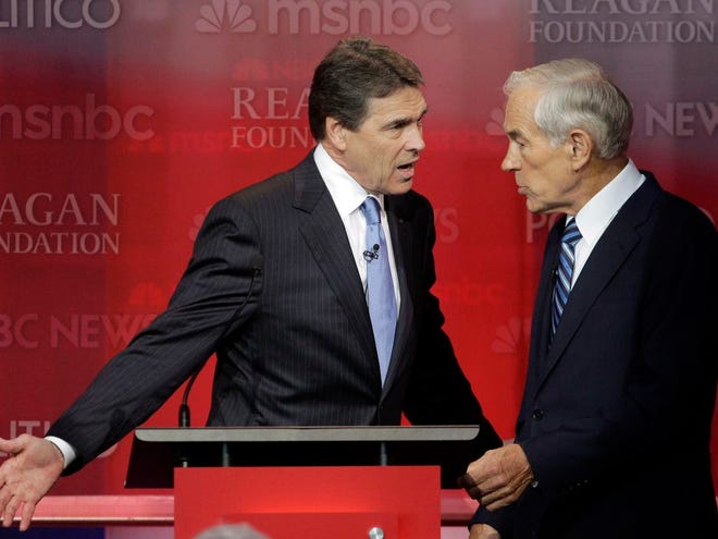 Republican presidential candidates Rick Perry, left, and Rep. Ron Paul, R-Texas, talk during a break at a Republican presidential candidates debate at the Reagan Library Wednesday in Simi Valley, Calif. (AP Photo/Jae C. Hong)