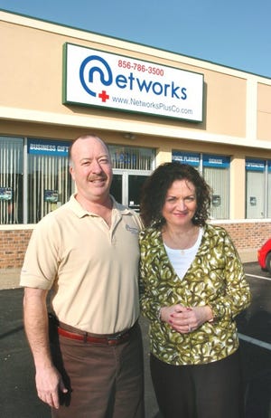 Jerry and Anne Caruso stand outside their business, Networks
Plus, in Cinnaminson last year. Jerry Caruso said 9/11 wasn't
exactly an "inspiration" for his business, but it was part of the
picture.
