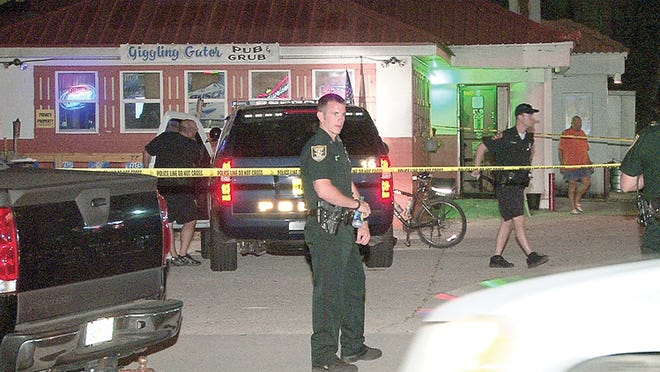 St. Augustine Police stand guard outside of Giggling Gator, 121 King St., following a deadly shooting late Saturday evening.