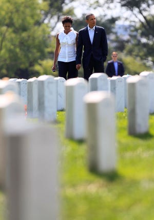 President Barack Obama and first lady Michelle Obama, left, visit Section 60 at Arlington National Cemetery, Saturday, Sept. 10, 2011, in Arlington, Va., to pay their respects to those who have made the ultimate sacrifice in the past decade.