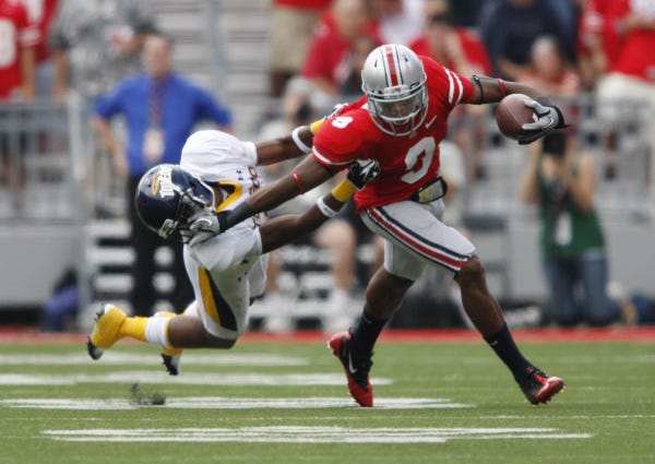 It took a while for the Buckeyes to shake the tenacious Toledo Rockets, including Taikwon Paige, trying to bring down Ohio State wide receiver Verlon Reed in the first quarter.