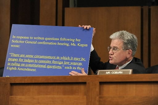 Senate Judiciary Committee member Sen. Tom Coburn, R-Okla., holds up a sign with a quote from Supreme Court nominee Elena Kagan during her confirmation hearing before the committee, Tuesday, June 29, 2010, on Capitol Hill in Washington. (AP Photo/Susan Walsh)