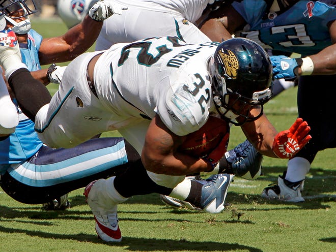 Jacksonville Jaguars running back Maurice Jones-Drew (32) dives through the Tennessee Titans defense during the second half of an NFL football game Sunday, Sept. 11, 2011, in Jacksonville, Fla. (The Associated Press)