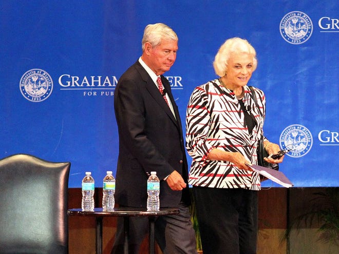 Former U.S. Supreme Court Justice Sandra Day O'Connor, joined by former Sen. Bob Graham, enters the University of Florida Auditorium to speak on Monday, Sept. 12, 2011, in Gainesville, Fla. (Erica Brough/The Gainesville Sun)