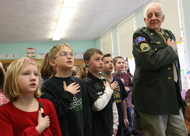 Second-graders say the pledge of allegiance with World War II veteran James Newell Thursday at the Central Elementary School in East Bridgewater in 2009.